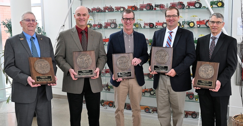 The 2022 class of five Iowa Master Farmers holding plaques