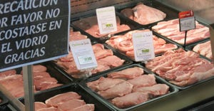 cuts of pork for sale at grocery meat counter