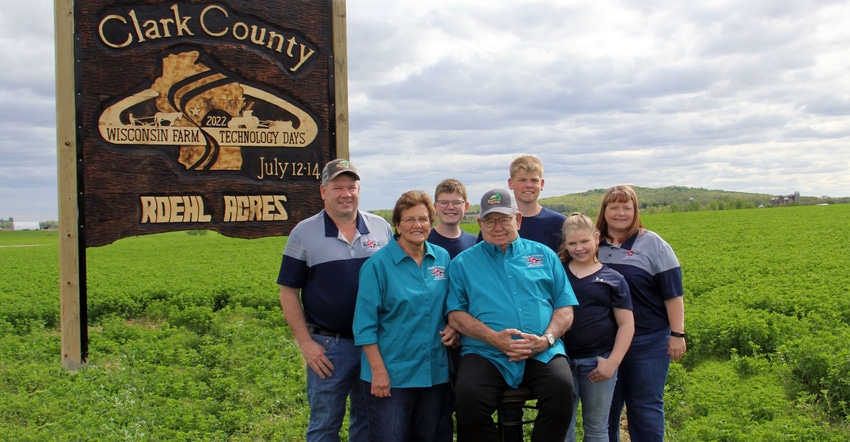 The Roehl family in front of a Wisconsin Farm Technology Days sign 