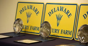 Delaware Century Farm families receive a sign for their farms, an engraved plate, a certificate and legislative tributes