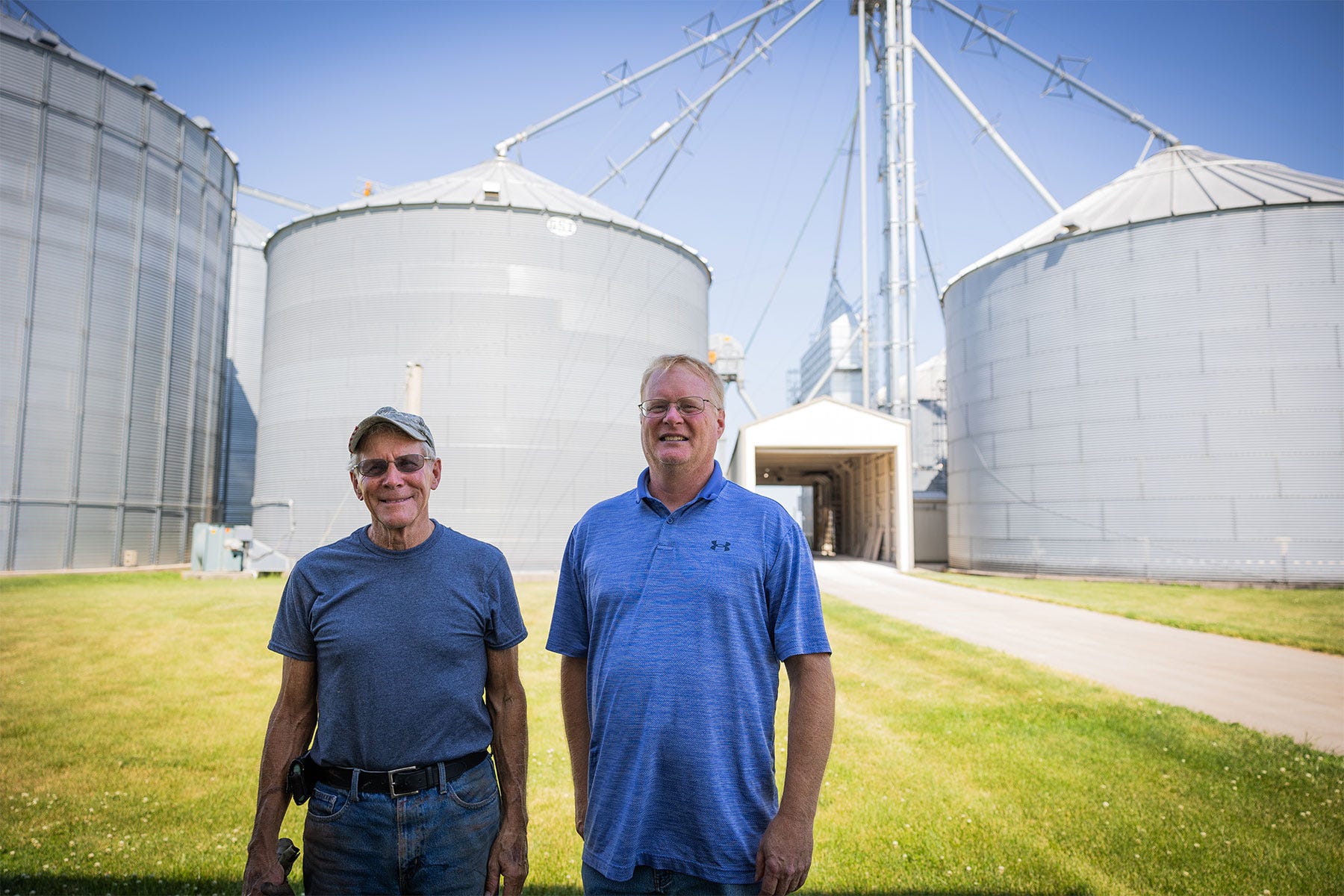 farmers Bill H. (left) and Bill R. Voorhees stand in front of their grain center