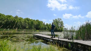 Kenny Cain standing on a dock looking over a body of water