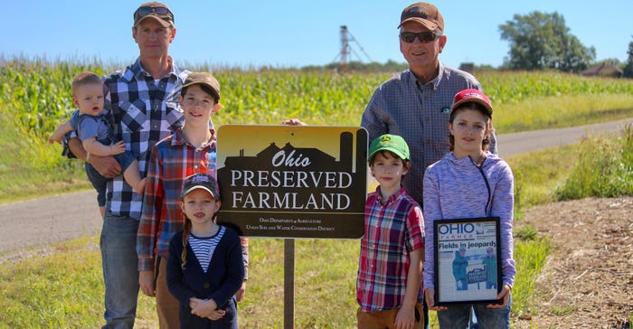 Pictured are Patrick Bailey with his children Angus, Elton, Marigold, Renner, Prairie and his father Don standing next to a s