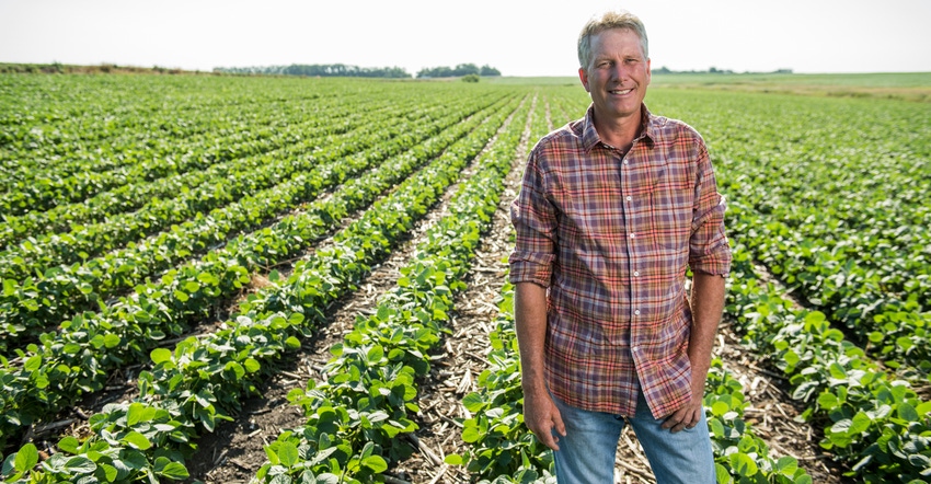 Todd Hanten standing in soybean field