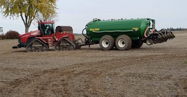 Tractor applying manure