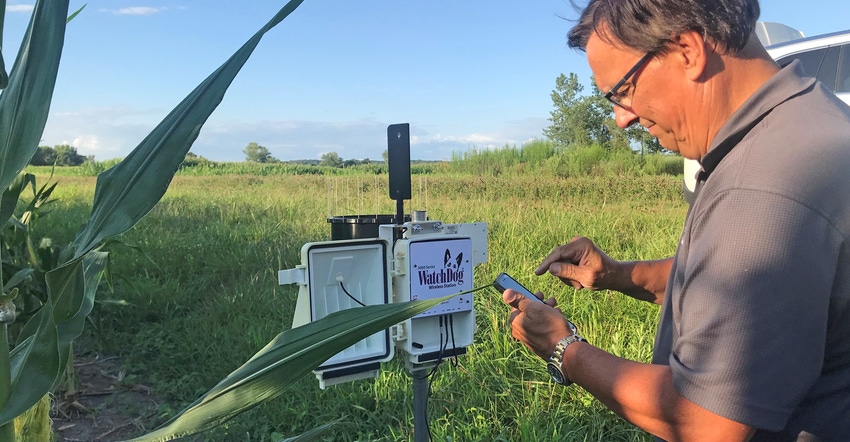 Mike Thurow adjusts the weather station on the Spangler farm 