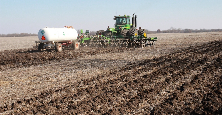 tractor, planter and fertilizer tank in field
