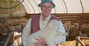 Glen Cauffman, Pure American Naturals owner, holds a baby Angora goat