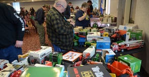 Shoppers look through a agriculture themed toys at a consignment sale