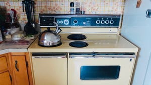 old electric oven in kitchen with tea kettle sitting on stove top