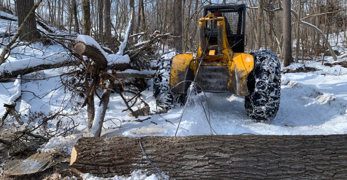  a “skidder” to removing a felled black walnut log from central Iowa woodland. 