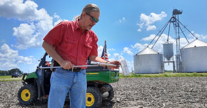 Terry Wyciskalla studies a soil sample in the field