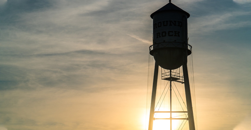 tank of water tower at sunset