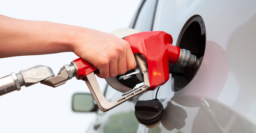 Person filling car with fuel Person filling car with fuel
