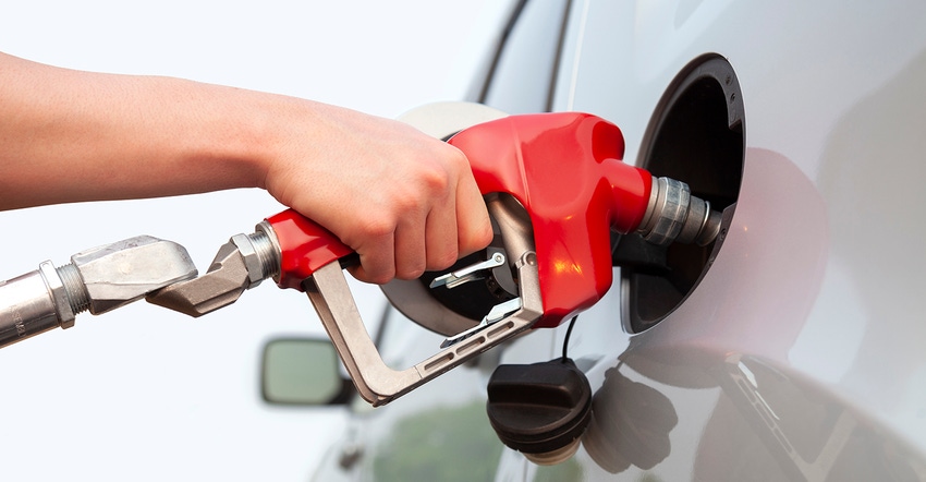 Person filling car with fuel