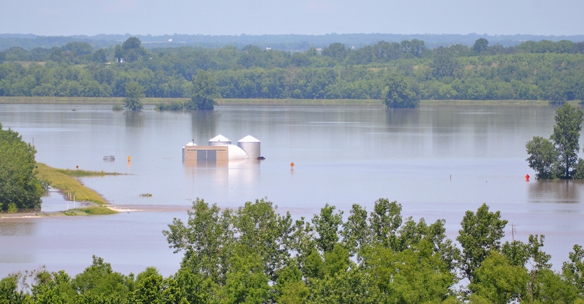 Flooded field with grain bins after levee fail