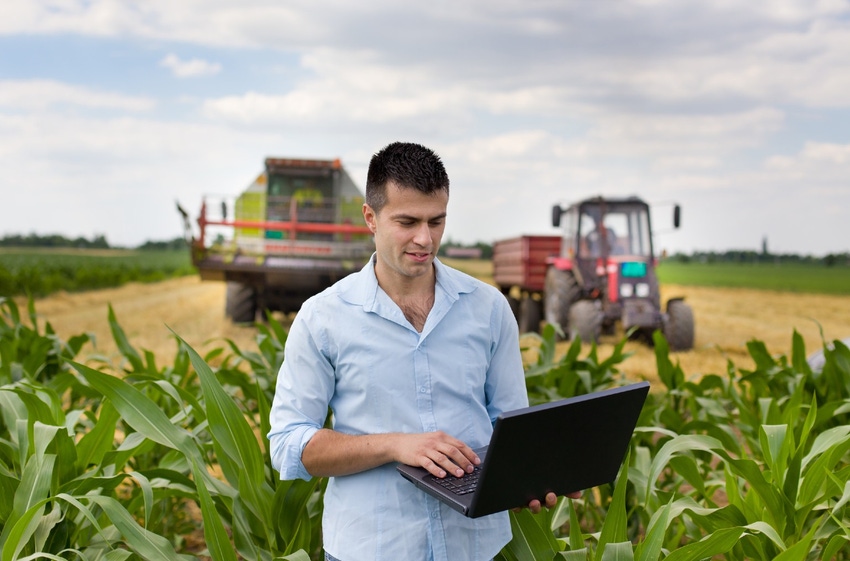 farmer-with-laptop-during-harvest-GettyImages-480915848.jpg