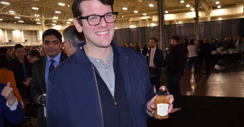 Brock Harpur displays a jar of Boiler Bee Honey