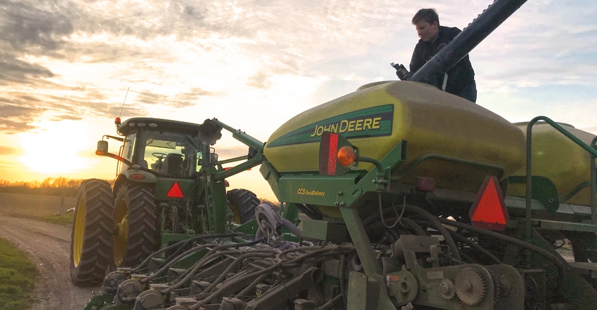 Nathan Spangler loading beans into planter at dusk Nathan Spangler loading beans into planter at dusk