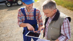 farmers using tablet for precision agriculture