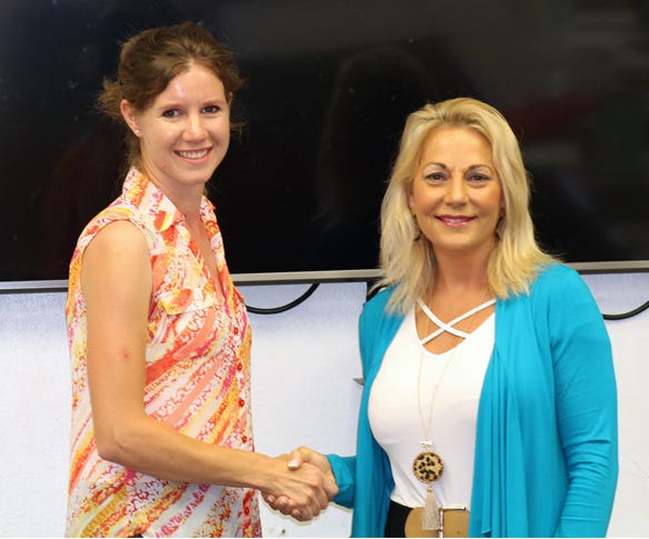 Rachel Hopkins, left, community engagement specialist with MU Extension, received the Conservationist of the Year award from the Women in NRCS. WIN President Sandi Kreke, right, presented the award.