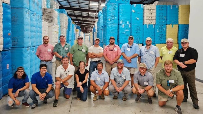 PIE Tour participants with cotton bales at CI Logistics
