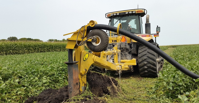 tractor in field digging hole