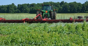 tractor and crimper in field of cover crops