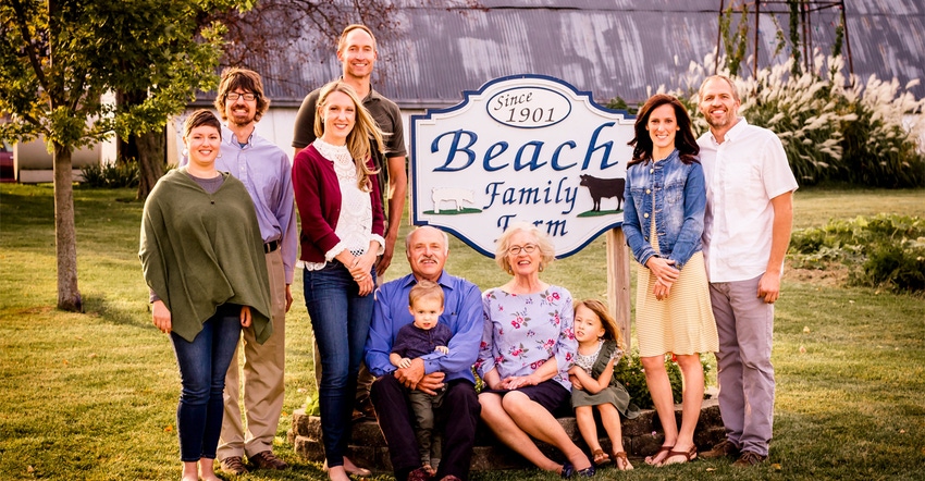 the Beach family in front of farm sign