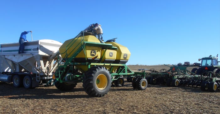 A three-compartment planter in field A three-compartment planter in field