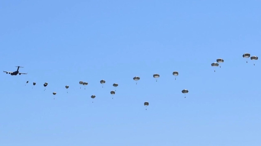 Nebraska Army National Guard paratroopers parachuting down from the sky