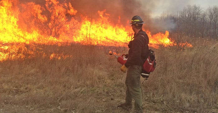 man watches controlled burn