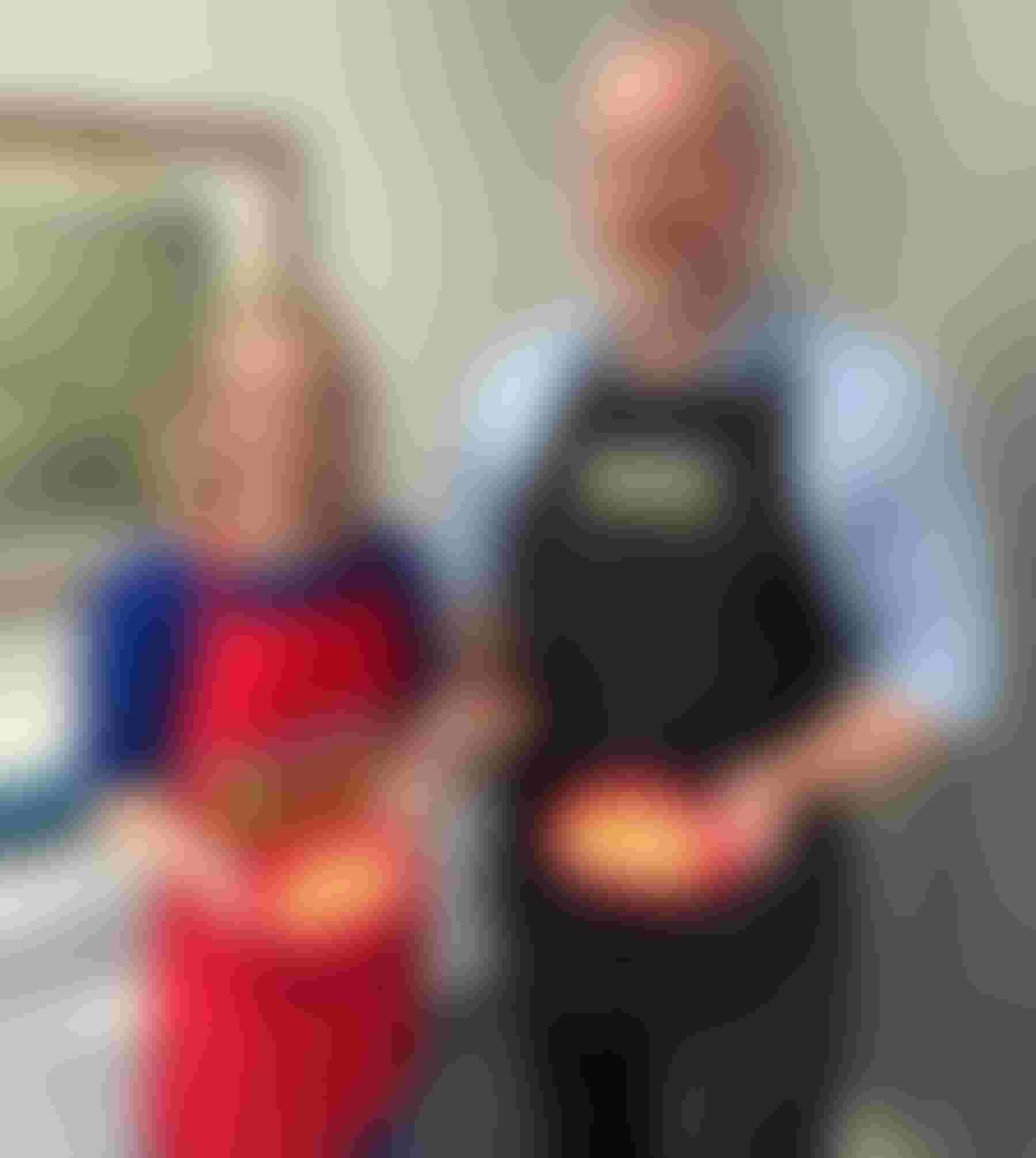 Wisconsin Agriculture Secretary Randy Romanski and Ashley Hagenow holding pancakes anmaple syrup