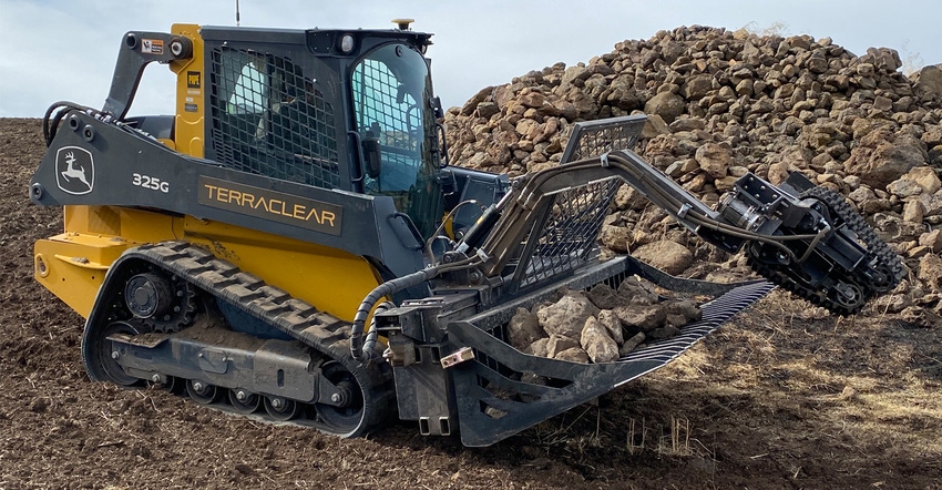 A TerraClear rock picker mounted to this compact track loader 