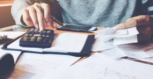 Man using calculator and calculate bills 