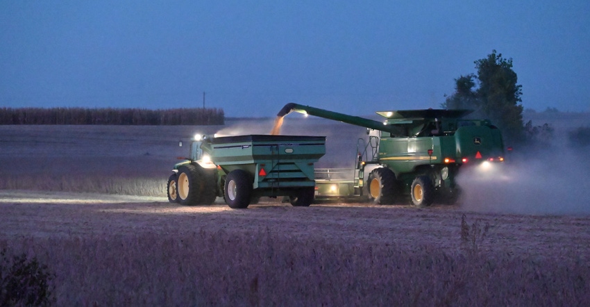 Soybean field with combine during harvest Soybean field with combine during harvest