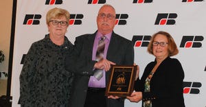 Vernon “Chip” Baker Jr. accepts the Farm Family of the Year Award presented to him and his wife, Judy