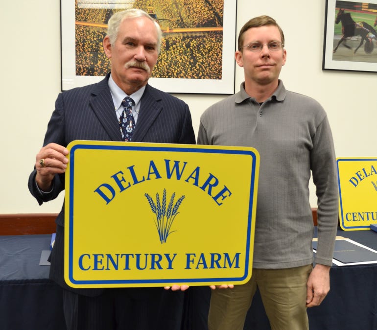 Mark Mihalik receives his family’s Century Farm Award from Michael T. Scuse, secretary of agriculture
