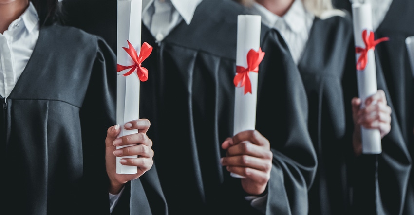 diplomas in the hands of graduates