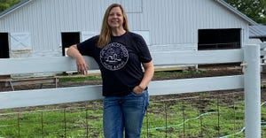 Jennifer Carrico standing in front of her barn on her farm