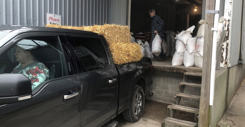 Pickup truck getting feed loaded on it at Shelby Farm Supply near Shelbyville, Ind.