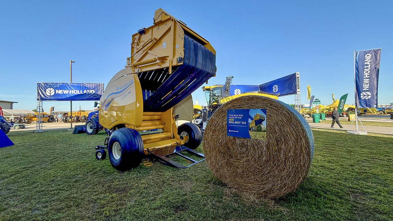 New Holland Roll-Belt 561 with a straw bale