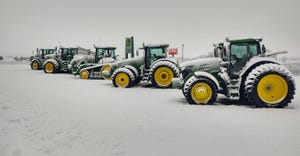 Row of tractors parked in snow