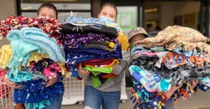 Boone County 4-H'ers Chloe, Zoe and Jolie Beal carrying blankets for Project Linus