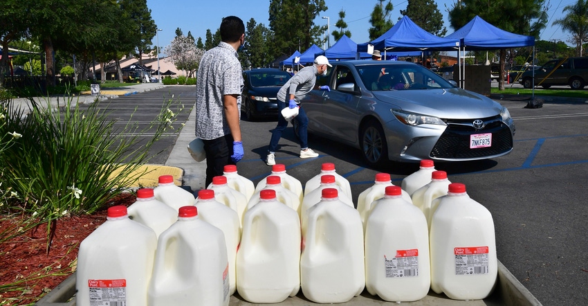 Gallons of milk on offer as volunteers help load food into vehicles