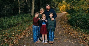 Nathan and Jennifer Brown standing with their children on rural road