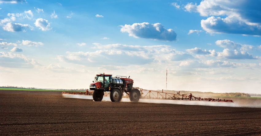 Sprayer equipment working a field Sprayer equipment working a field