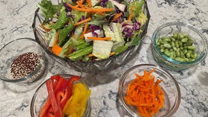 Glass bowls filled with salad and various different vegetables