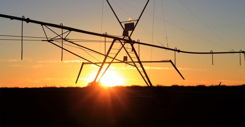 Pivot sprinkler at sunset Pivot sprinkler at sunset