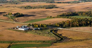 aerial view of farm surrounded by fields